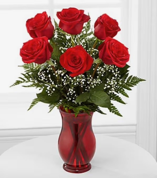 Dozen red roses in vase
